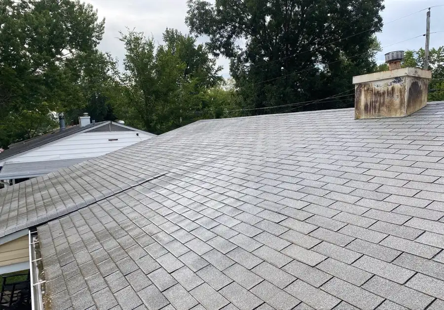 The same roof after a low-pressure soft wash, the grey shingle granules visible again