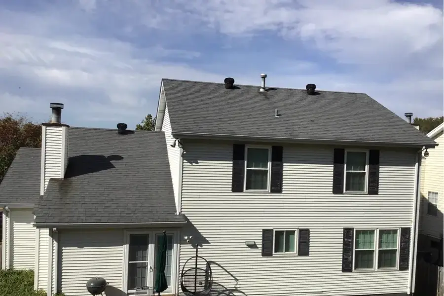 Asphalt shingle roof on a St. Louis County home showing dark algae streaking before cleaning